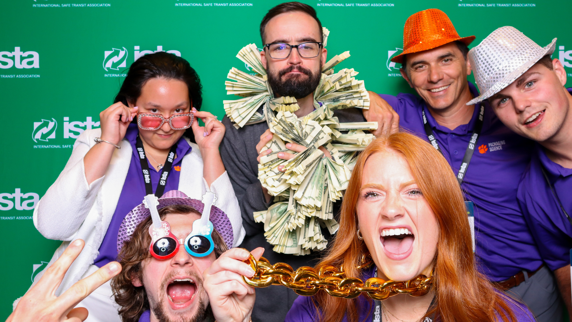 Attendees smile for a photo wearing sunglasses
