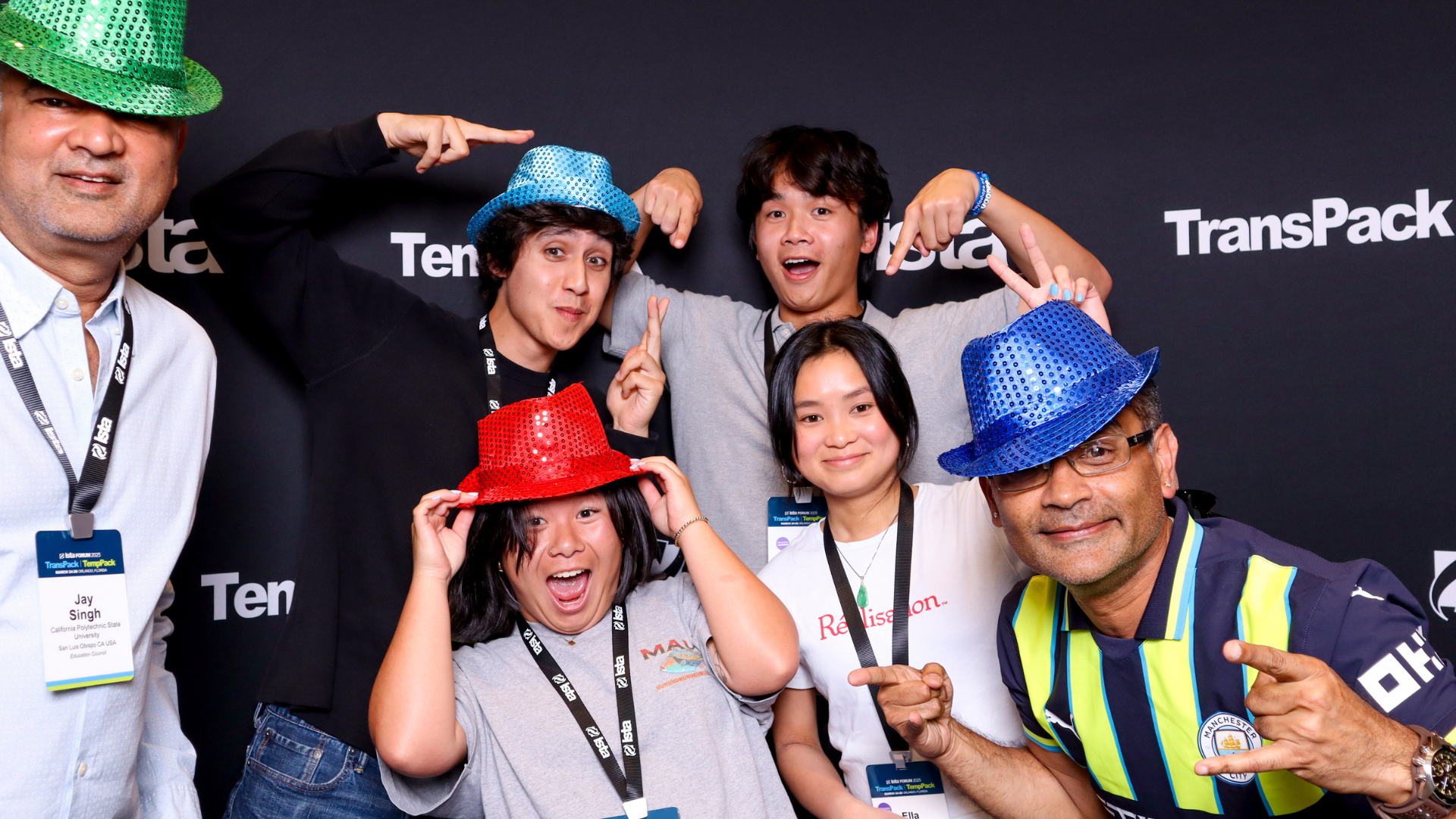 Attendees smile for a photo wearing sunglasses
