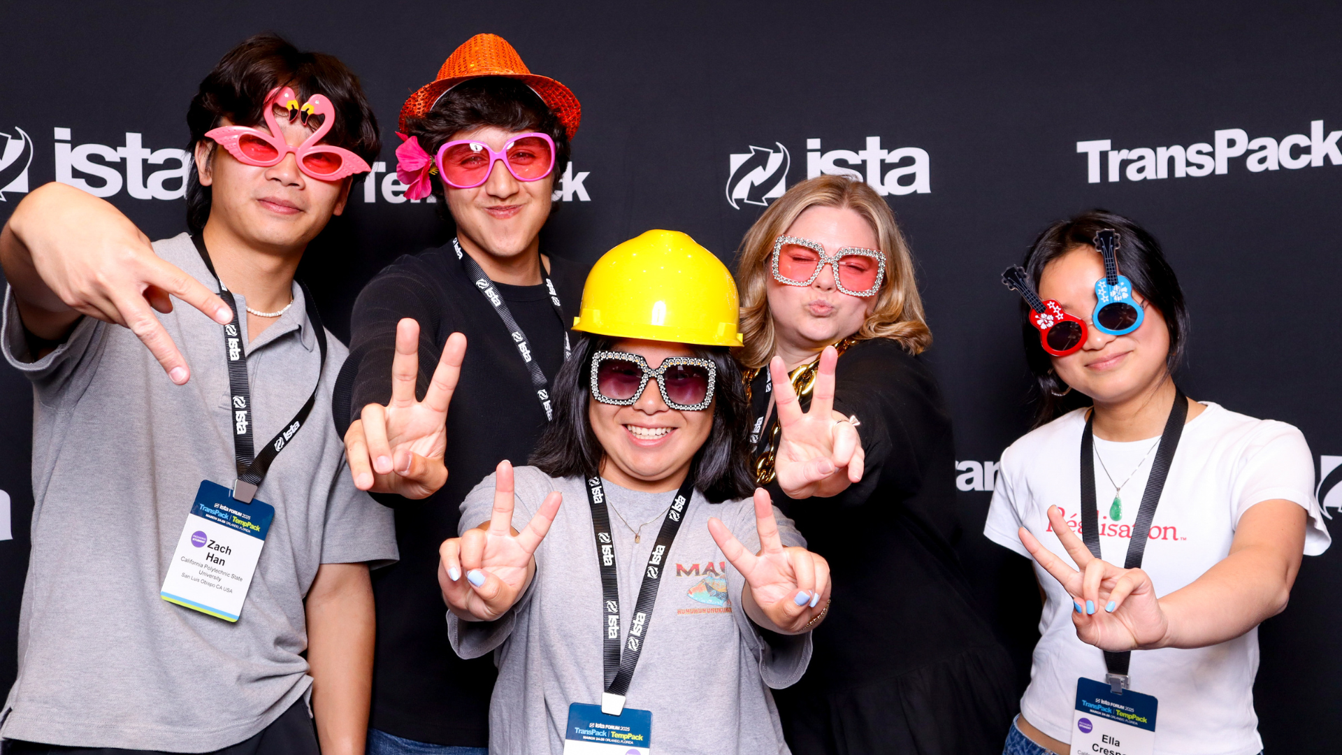 Attendees smile for a photo wearing sunglasses